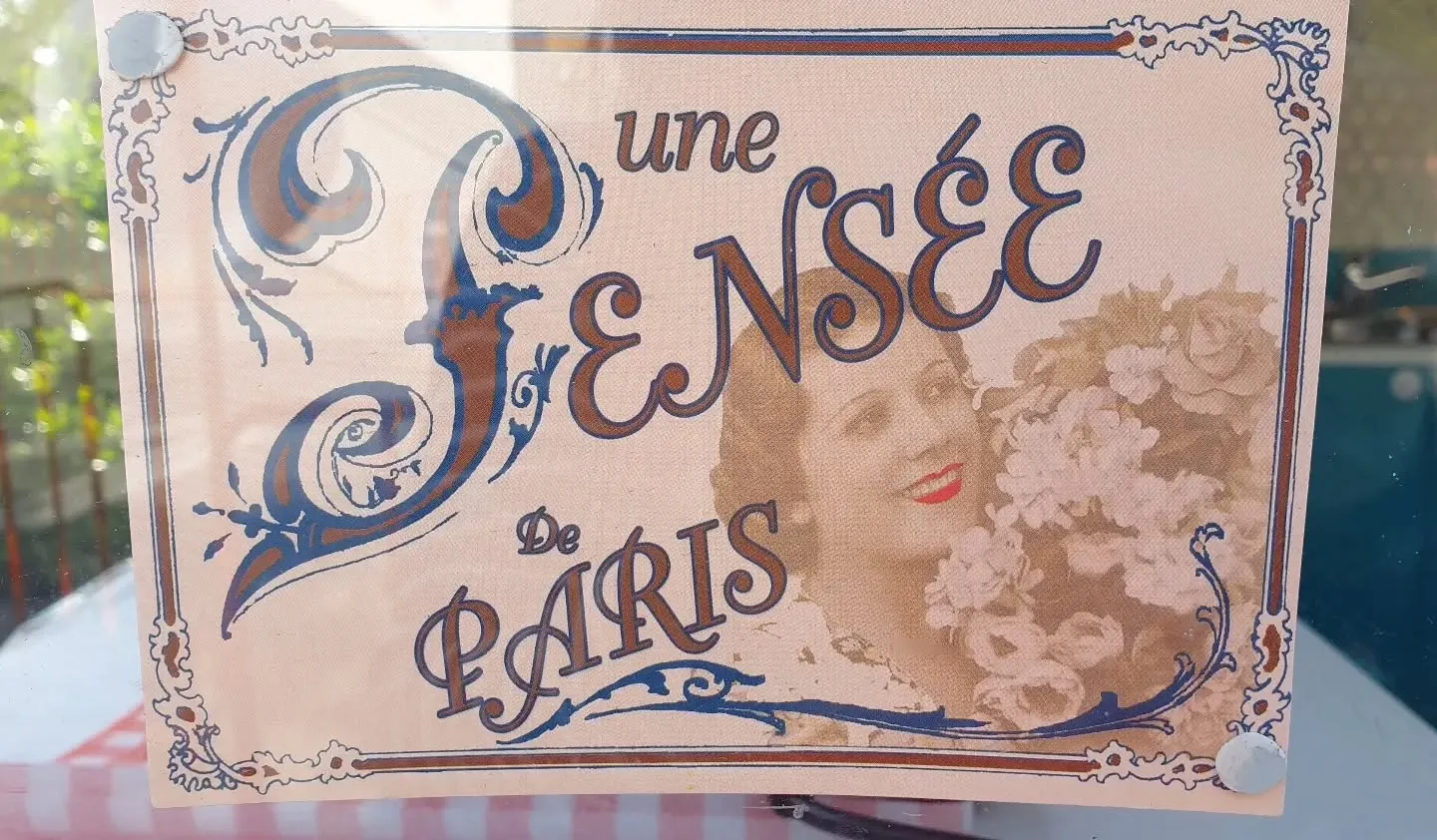 Vintage 'Une Pensee de Paris' decorative French print displayed on the caravan